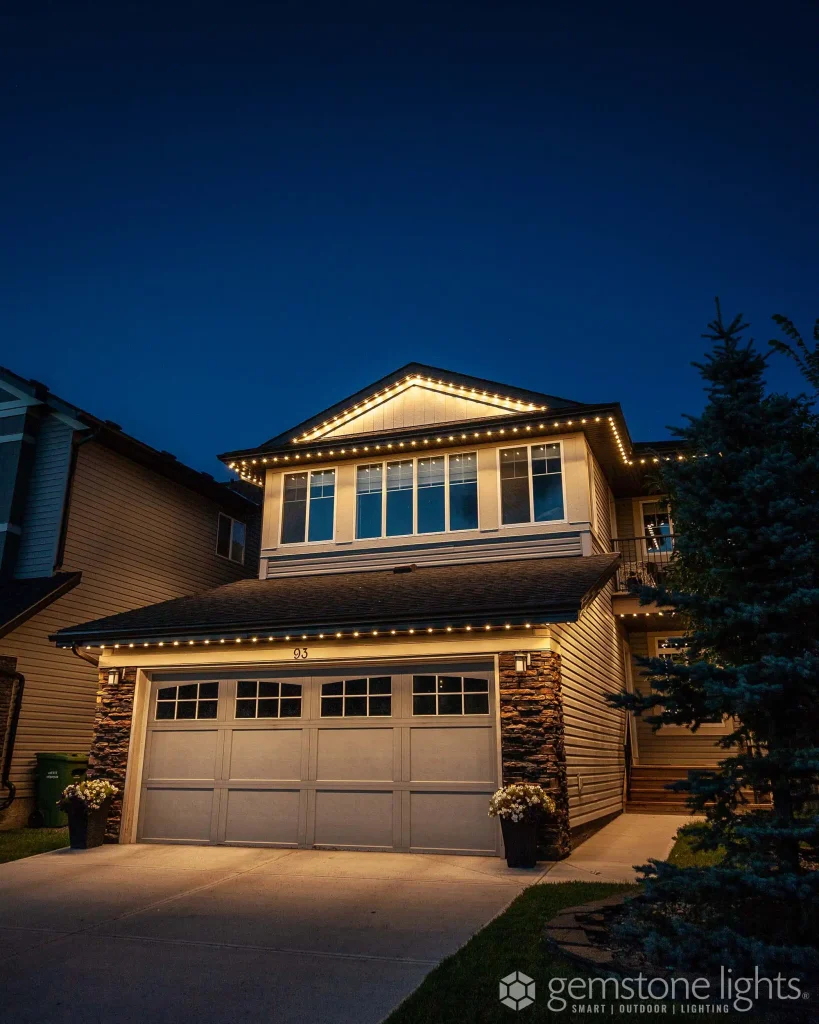 Permanent outdoor lighting Barrie illuminates a house beautifully against a twilight sky