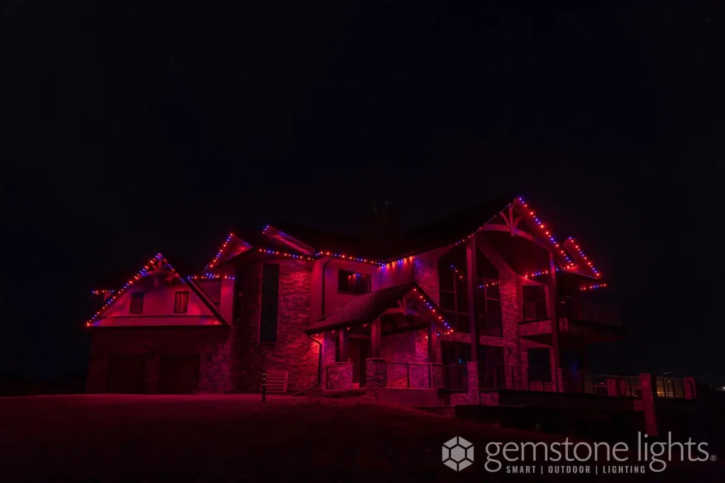 Halloween themed Gemstone Lights in orange and purple creating a spooky glow on a family home