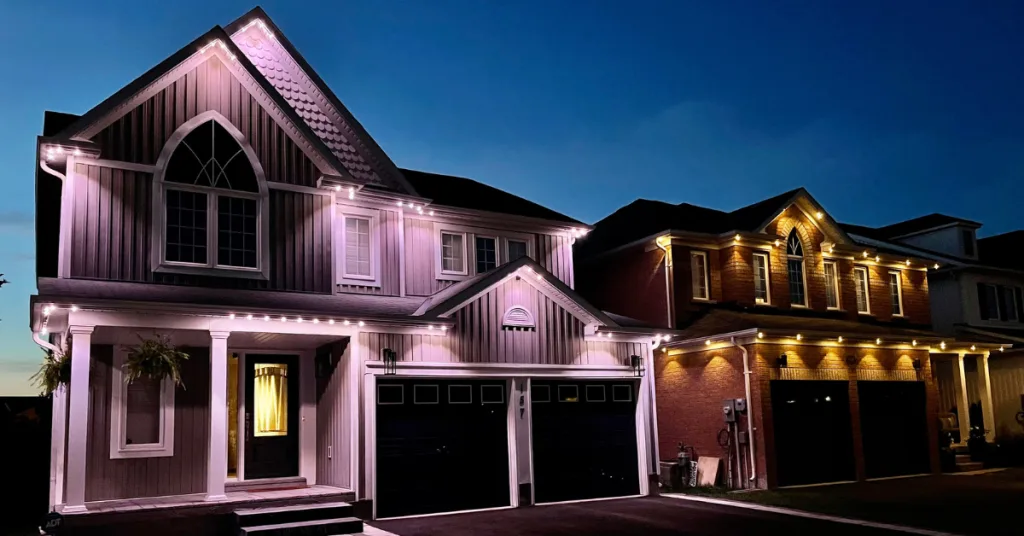 A beautifully lit house glows softly in the evening dusk