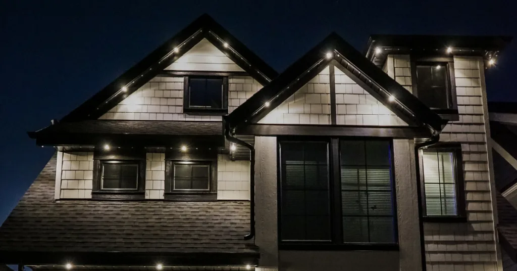 A beautifully illuminated house showcases stylish architectural features at night